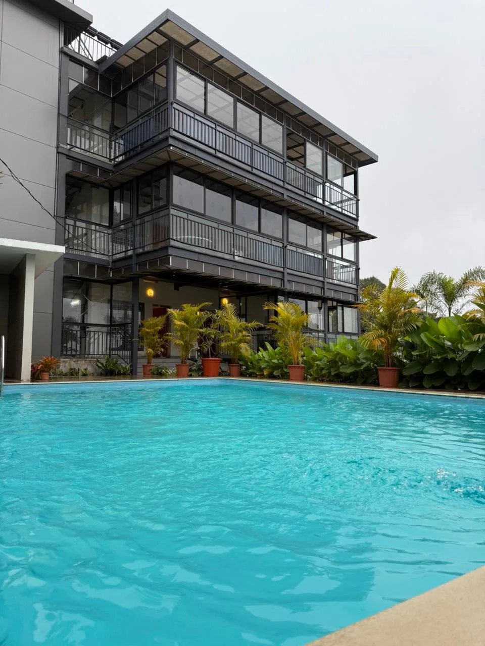 The building seen from the far end of the pool