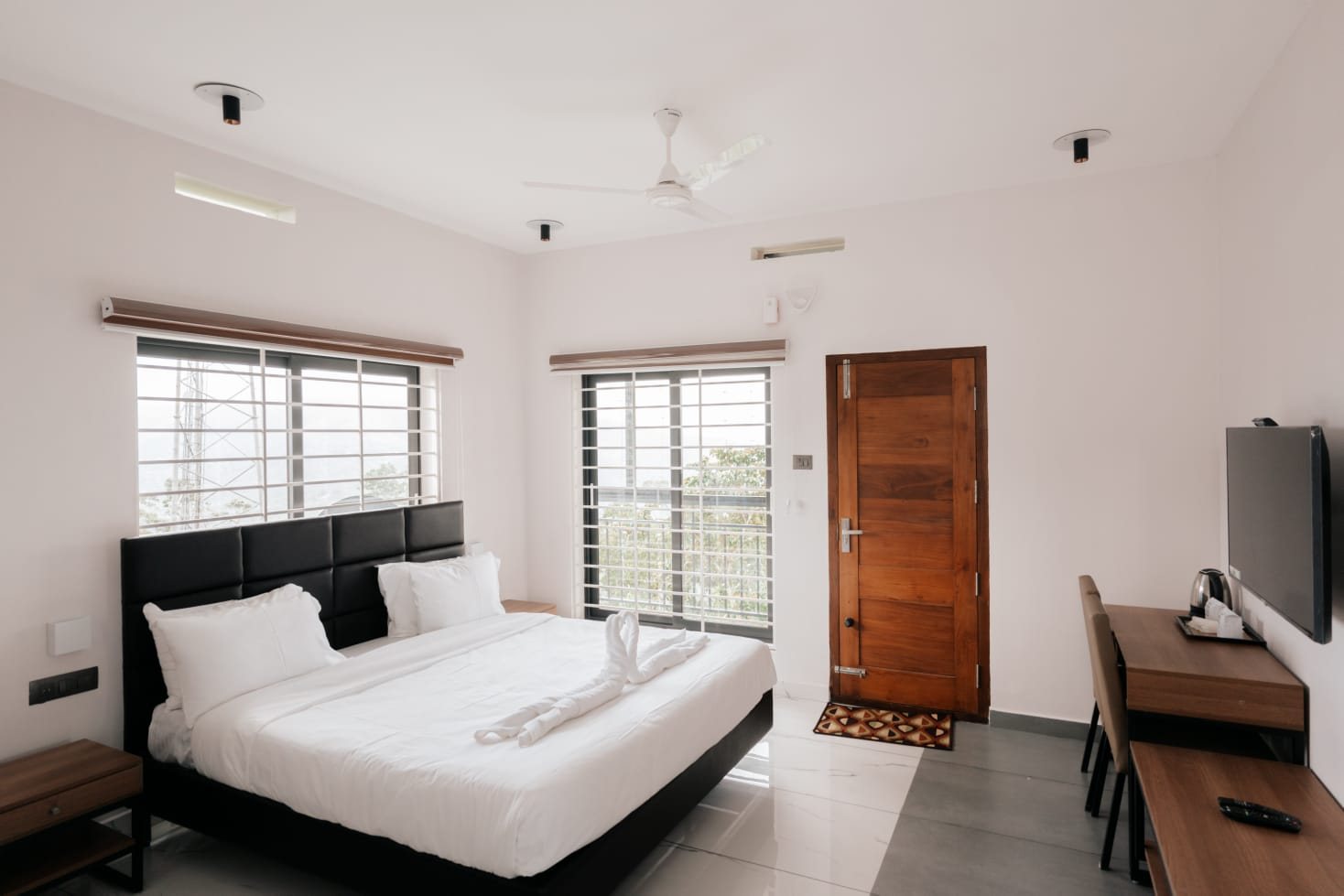 A room with two windows facing the valley